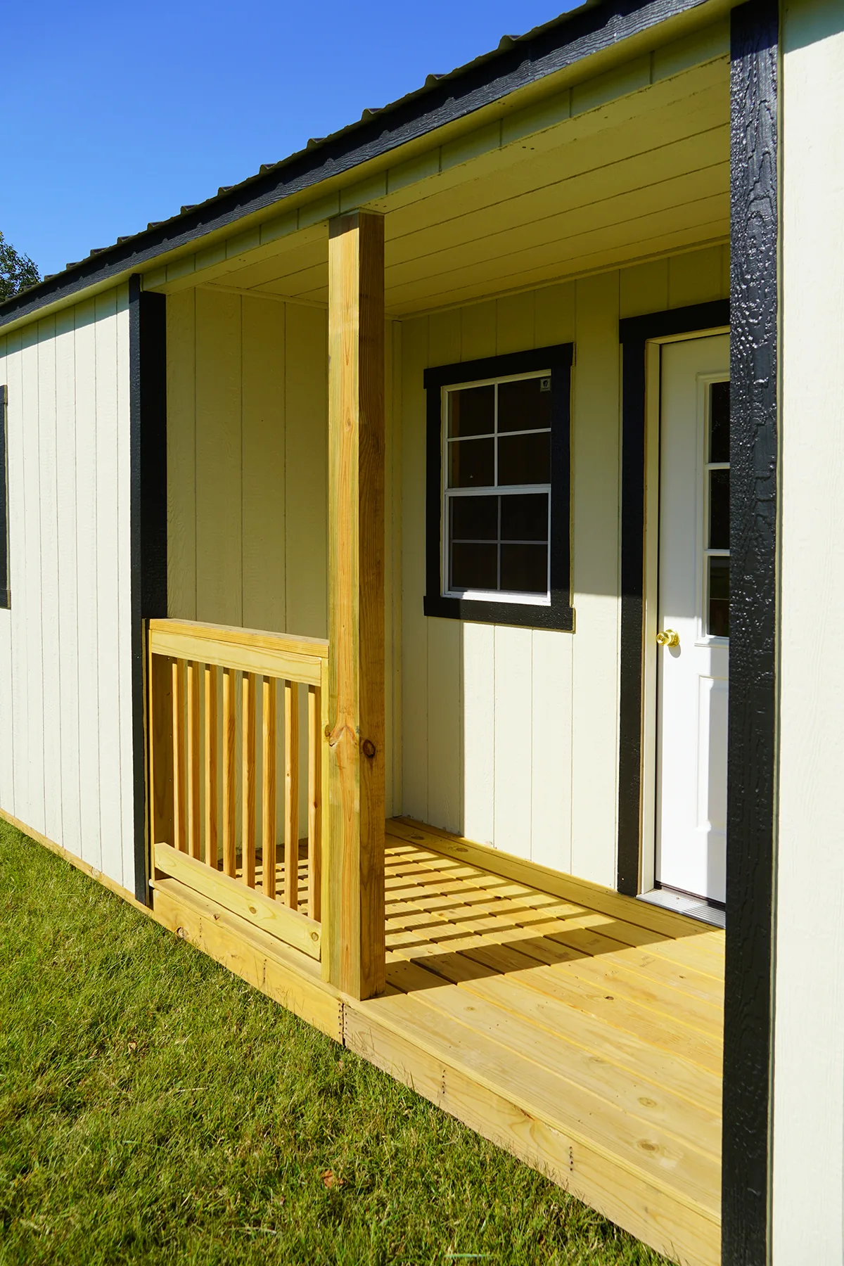 Porch, window, and entry door of a Premier center cabin shell