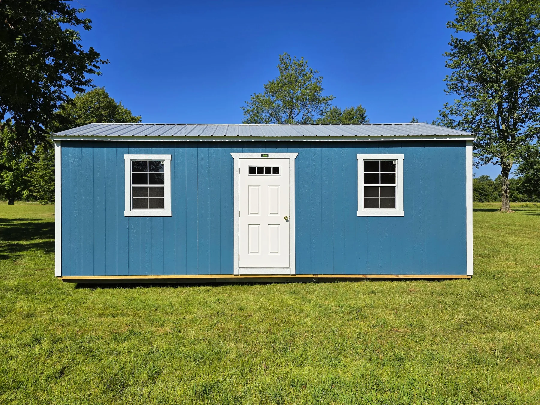 Blue Premier garage shell with a walk door and two windows
